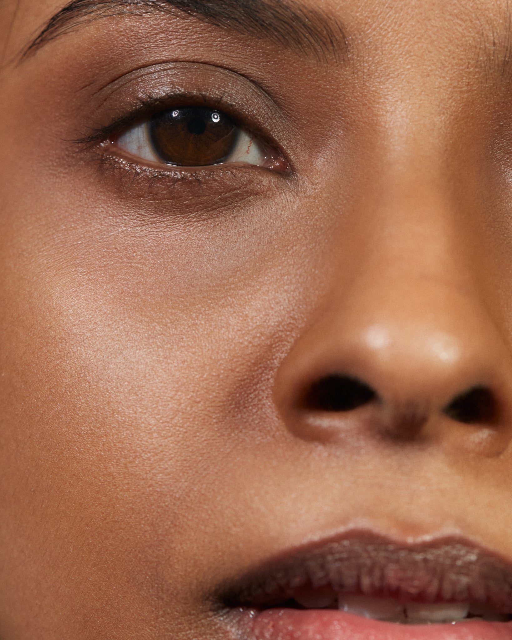 Model wearing MÁDARA Organic Skincare air equal powder deep on A6803 on skin; close-up portrait shows natural application results.