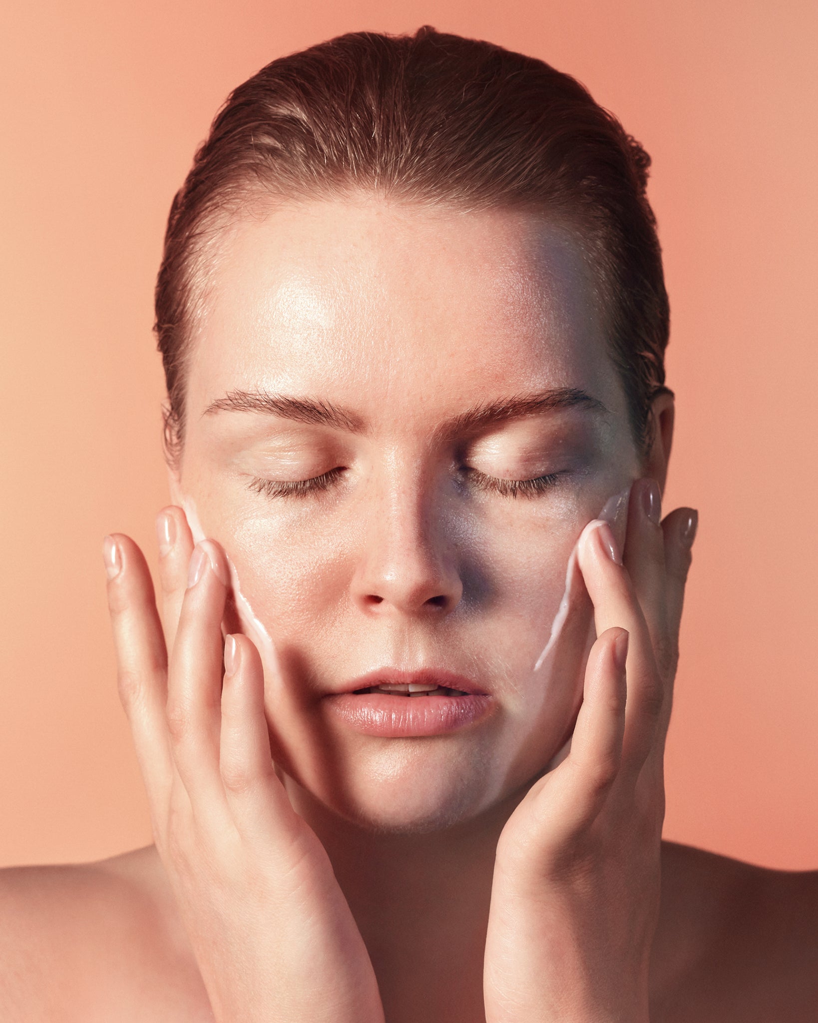 Model wearing MÁDARA Organic Skincare hyaluronic acid face cream SM3011 15 face cream on skin; close-up portrait shows natural application results.