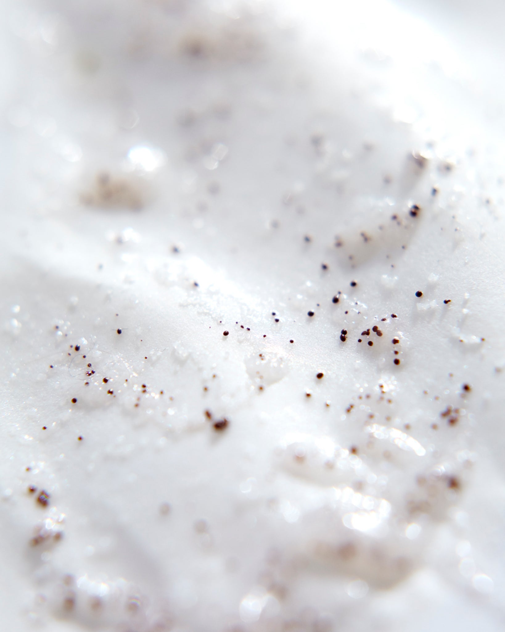 Model wearing MÁDARA Organic Skincare oil based face scrub A2151 face oil on skin; close-up portrait shows natural application results.