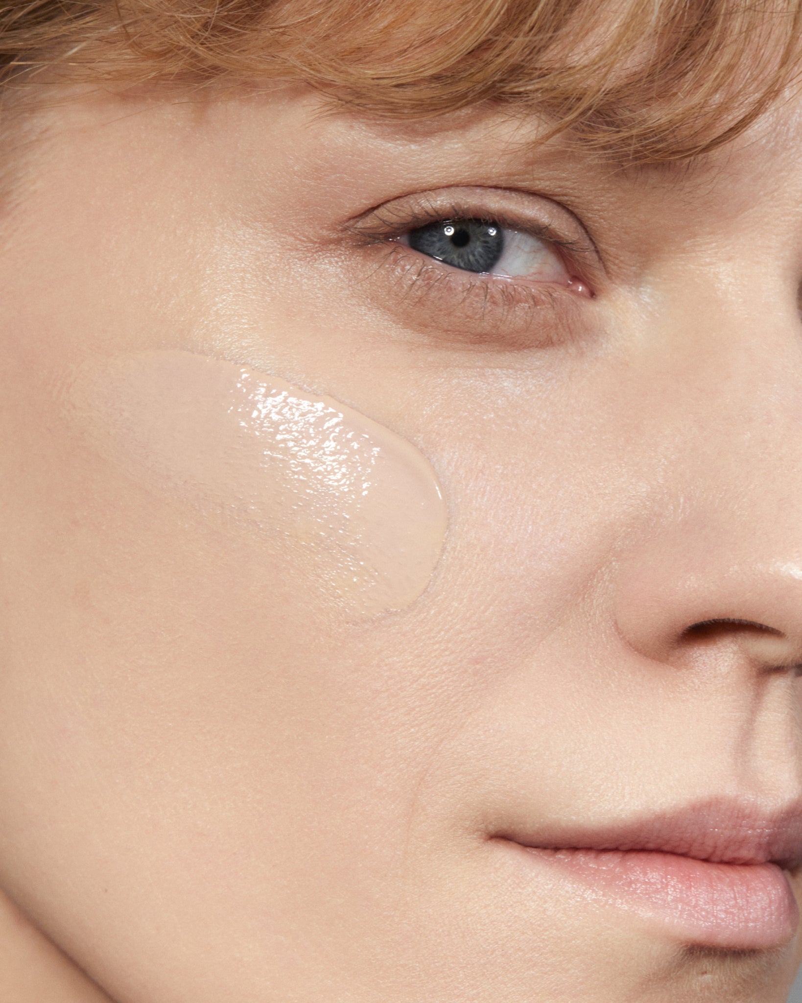 Model wearing MÁDARA Organic Skincare skinonym stone on A6087 on skin; close-up portrait shows natural application results.