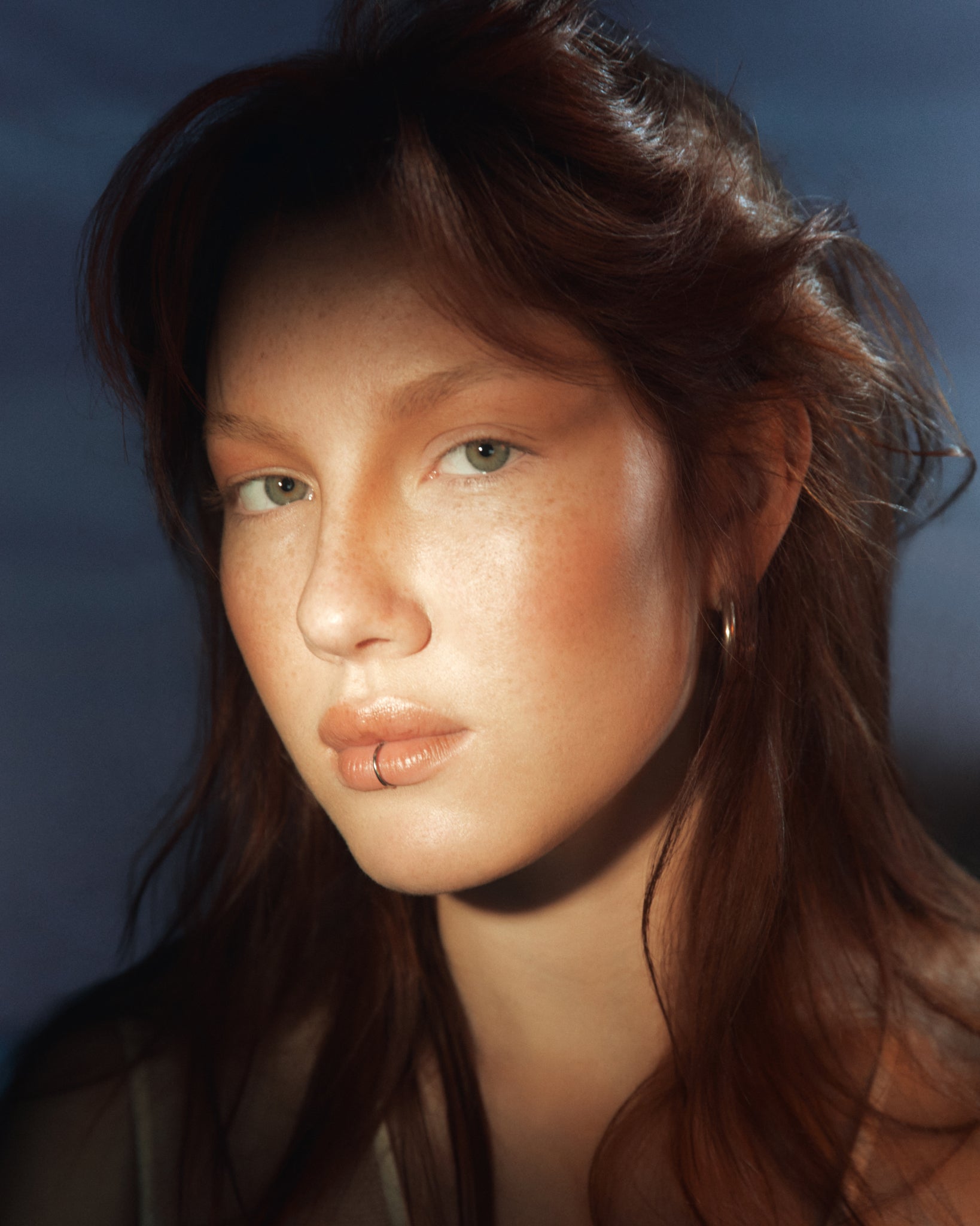 Model wearing MÁDARA Organic Skincare bronzer on madara A6841 on skin; close-up portrait shows natural application results.