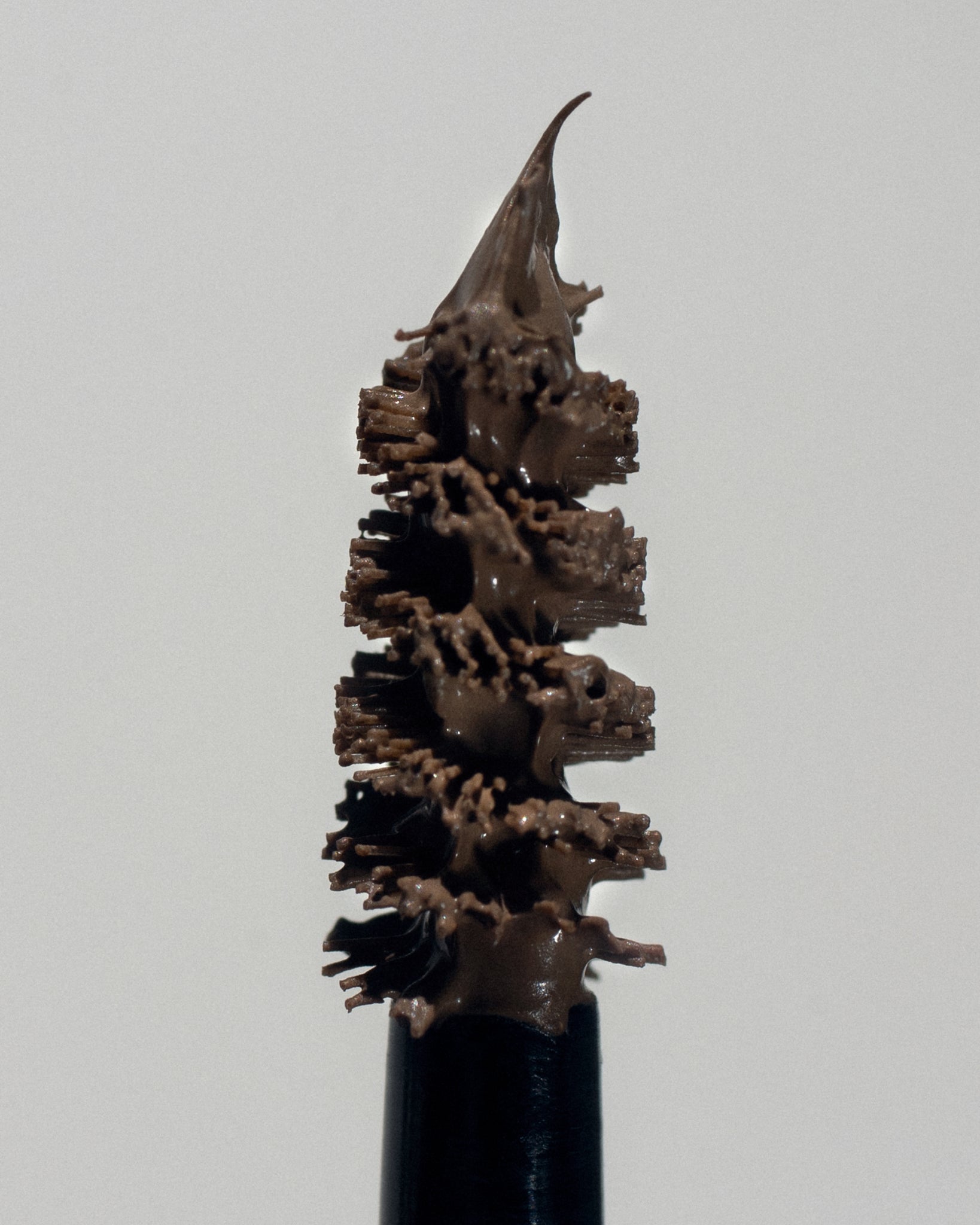 Texture close-up of MÁDARA Organic Skincare grow and fix ash brown A6704 �swatch demonstrates consistency and finish.