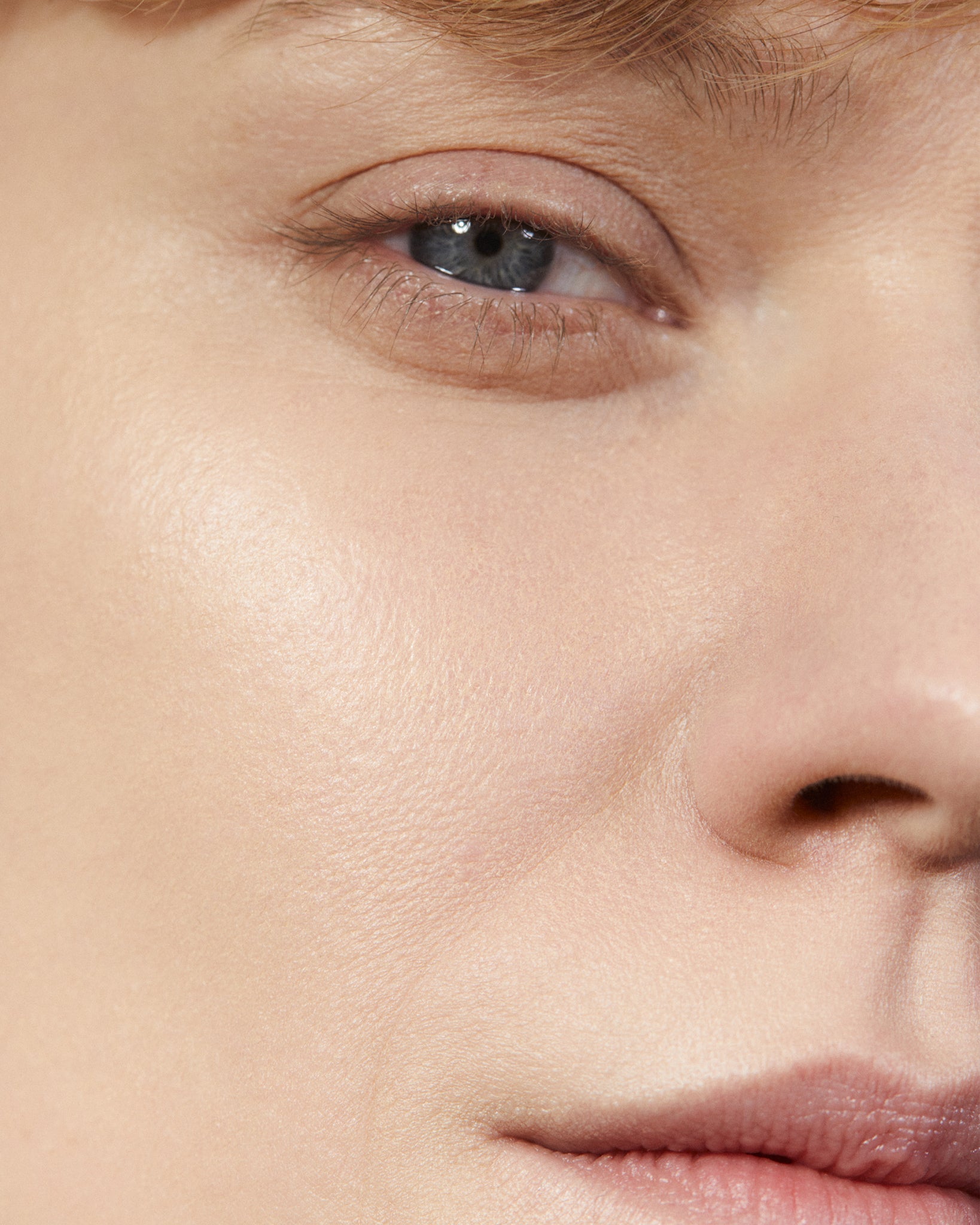 Model wearing MÁDARA Organic Skincare soft silk powder fair on A6801 on skin; close-up portrait shows natural application results.