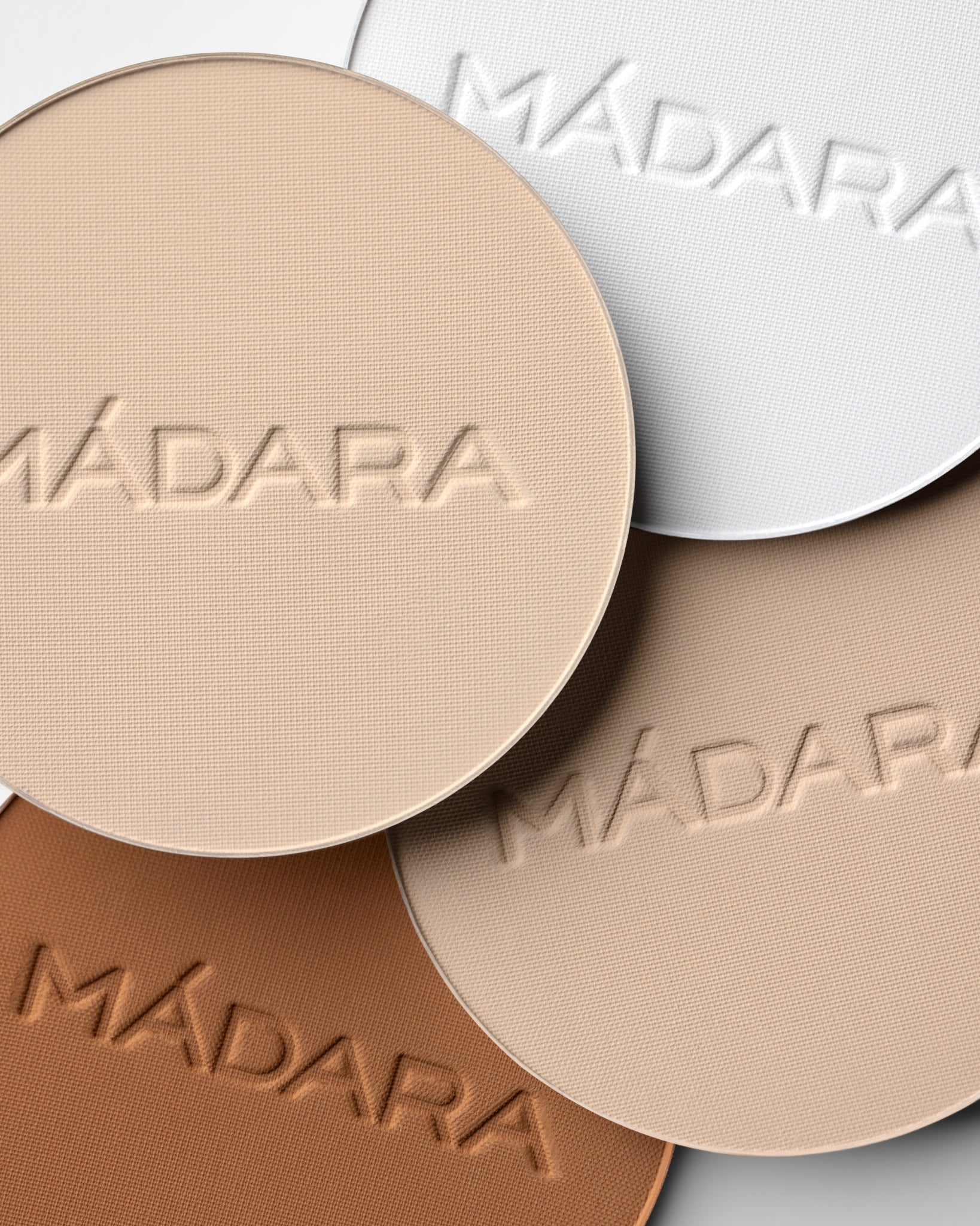 Texture close-up of MÁDARA Organic Skincare soft silk mineral powder textures A6800 �swatch demonstrates consistency and finish.
