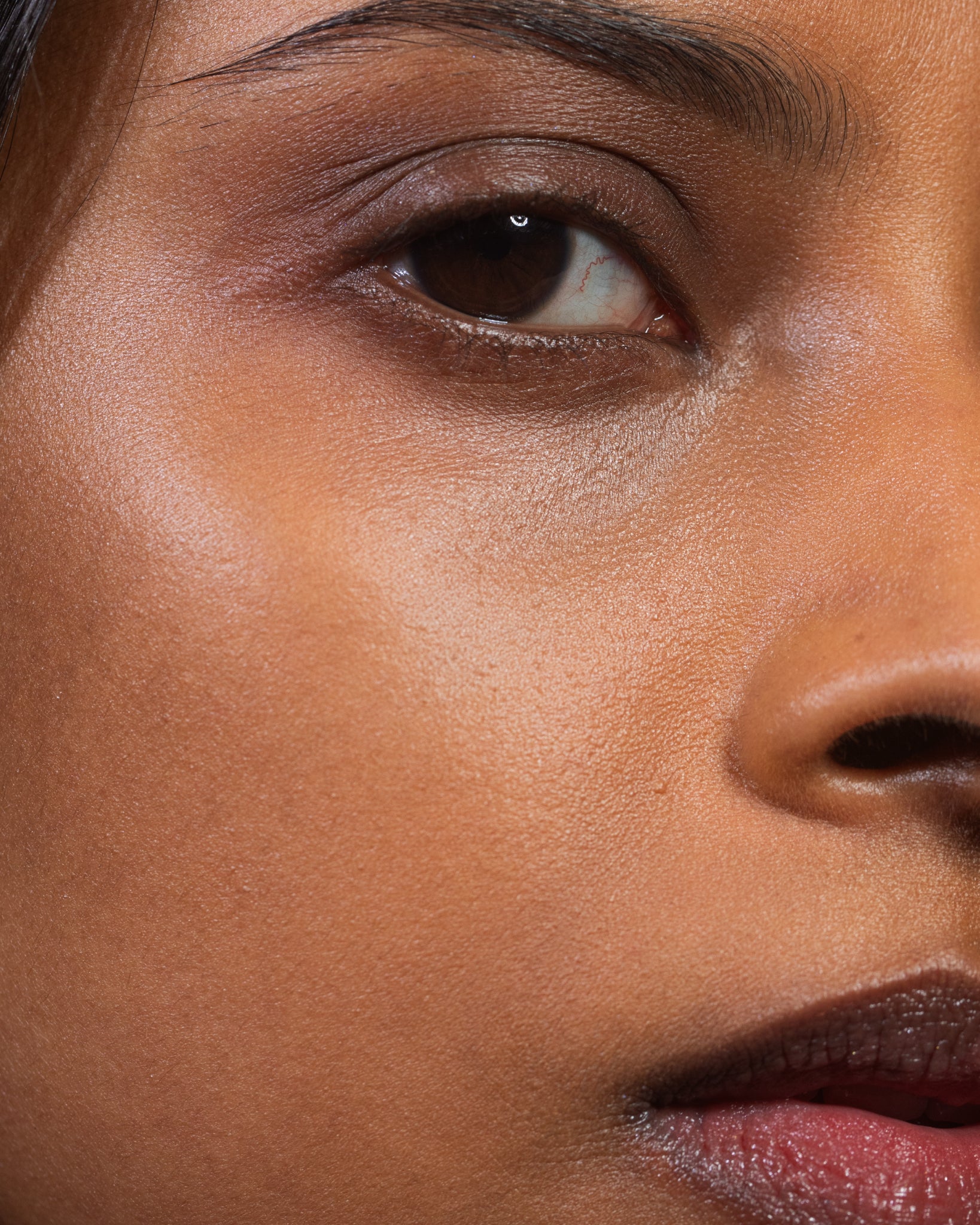 Model wearing MÁDARA Organic Skincare dream flower serum on A3515 serum on skin; close-up portrait shows natural application results.