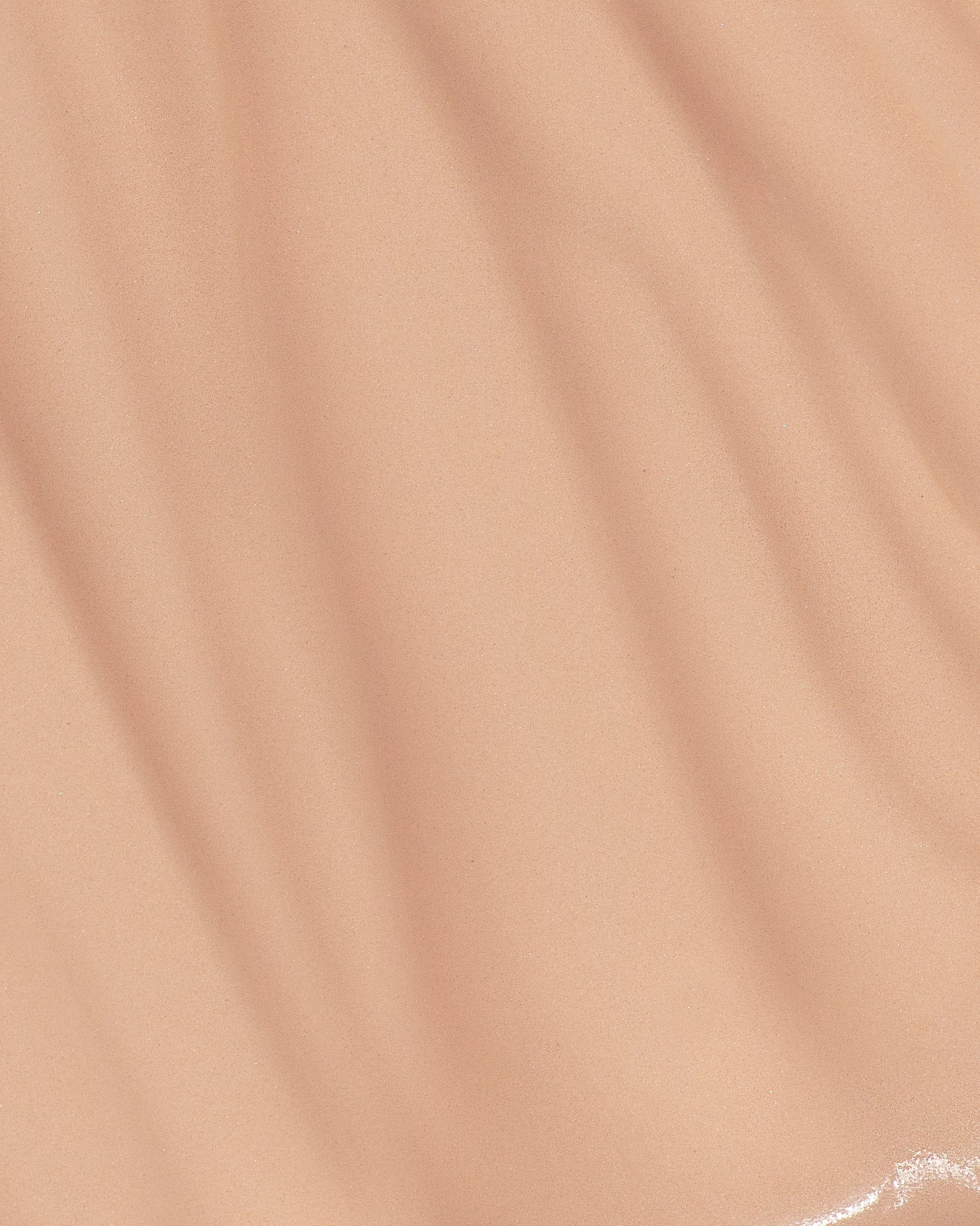 Texture close-up of MÁDARA Organic Skincare skin equal foundation rose ivory A6055 foundation �swatch demonstrates consistency and finish.